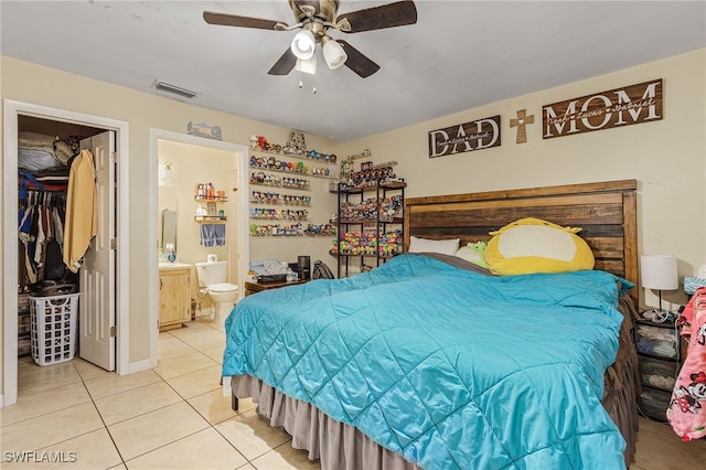 bedroom featuring ceiling fan, light tile patterned flooring, and connected bathroom