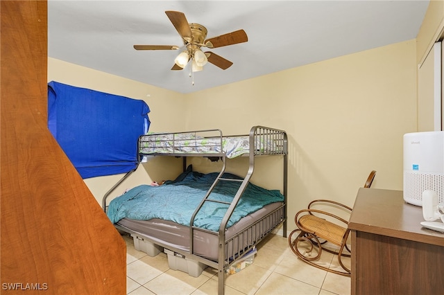 tiled bedroom with ceiling fan