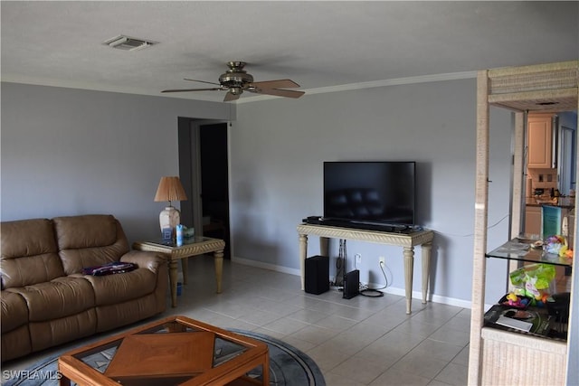 tiled living room with ceiling fan and crown molding