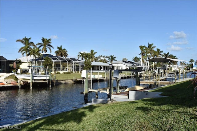 dock area featuring a lawn and a water view