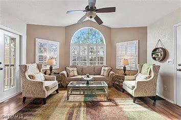 living room featuring ceiling fan, wood-type flooring, and lofted ceiling