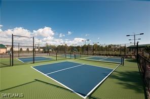 view of tennis court featuring basketball court