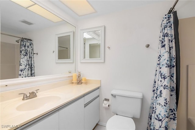 bathroom featuring vanity, curtained shower, and toilet