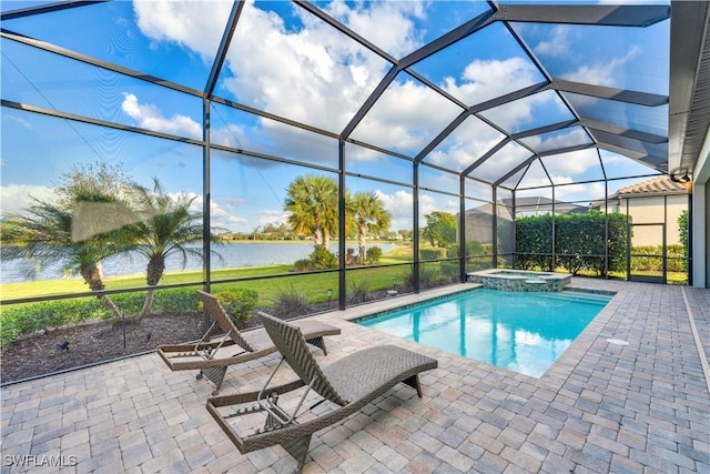 view of swimming pool featuring glass enclosure, a patio area, a water view, and an in ground hot tub