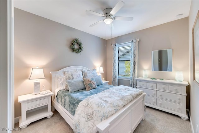 bedroom featuring light carpet and ceiling fan