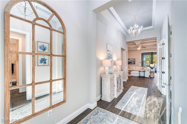 hall featuring dark wood-type flooring and a notable chandelier