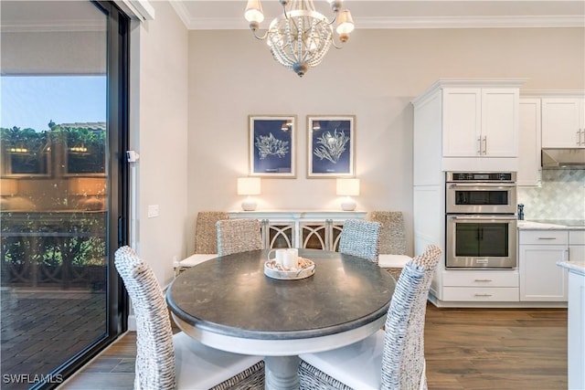 dining room featuring a notable chandelier, ornamental molding, and dark wood-type flooring