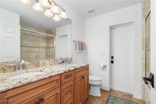 bathroom featuring tile patterned floors, toilet, an enclosed shower, and vanity