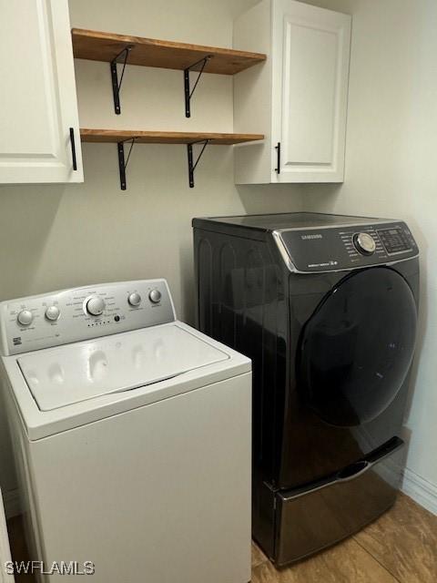 washroom with light hardwood / wood-style floors, cabinets, and independent washer and dryer