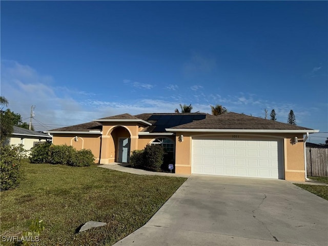 ranch-style home with a garage and a front lawn