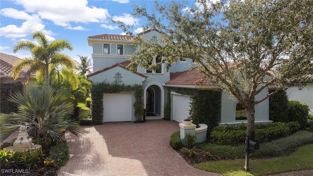 mediterranean / spanish-style house with a garage