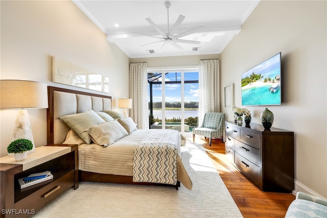 bedroom featuring beam ceiling, access to exterior, ceiling fan, and light wood-type flooring