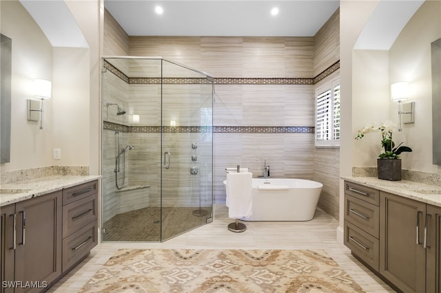 bathroom with vanity and separate shower and tub