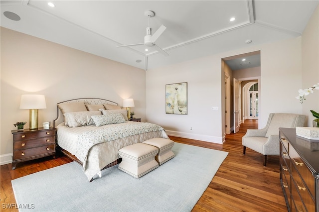 bedroom featuring dark hardwood / wood-style floors, ceiling fan, and lofted ceiling