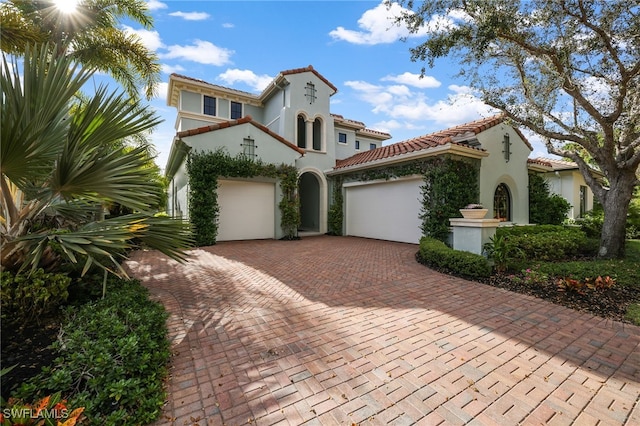 mediterranean / spanish house featuring a garage