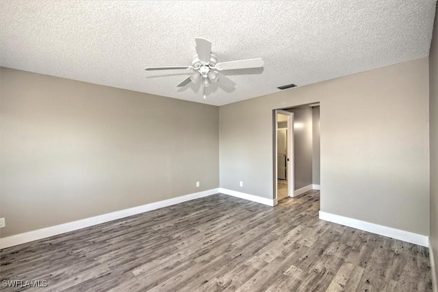 unfurnished room with ceiling fan, hardwood / wood-style floors, and a textured ceiling