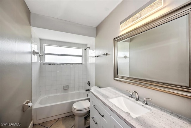 full bathroom with tiled shower / bath, tile patterned flooring, vanity, and toilet