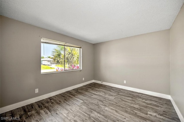 unfurnished room featuring a textured ceiling and hardwood / wood-style flooring