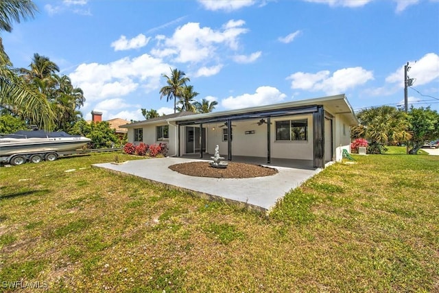 back of house with a lawn