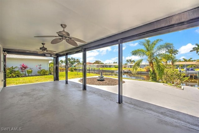 view of patio featuring a water view and ceiling fan