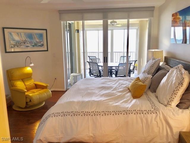 bedroom featuring access to exterior and dark hardwood / wood-style floors