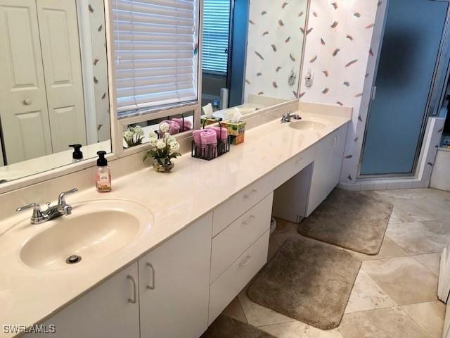 bathroom with vanity and a shower with shower door