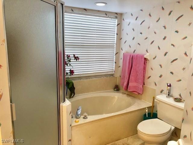 bathroom featuring shower with separate bathtub, toilet, and tile patterned floors