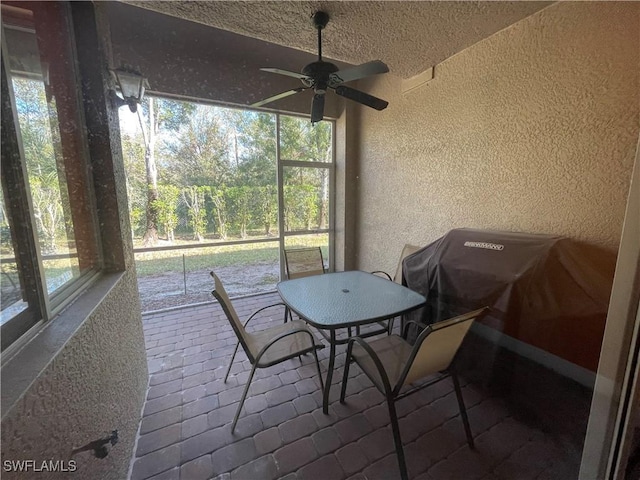 sunroom / solarium with ceiling fan and a healthy amount of sunlight