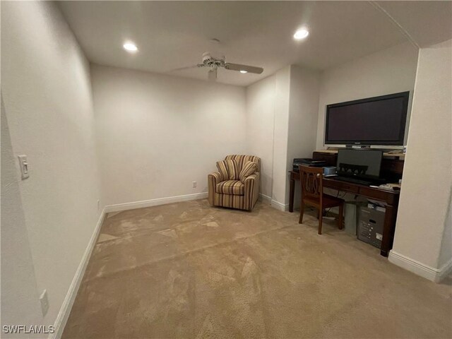 carpeted office space with ceiling fan