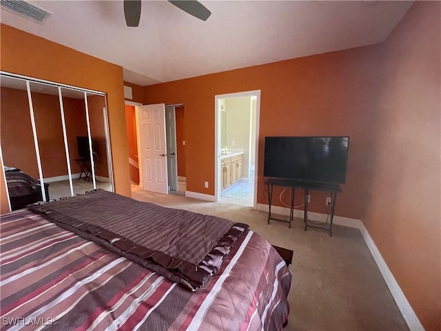 bedroom with visible vents, baseboards, ceiling fan, carpet flooring, and ensuite bath