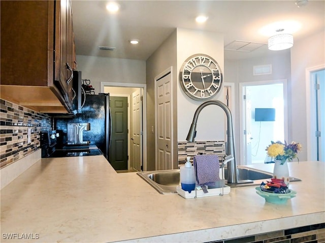 kitchen with backsplash and black stove