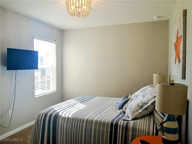 bedroom featuring carpet floors and a notable chandelier