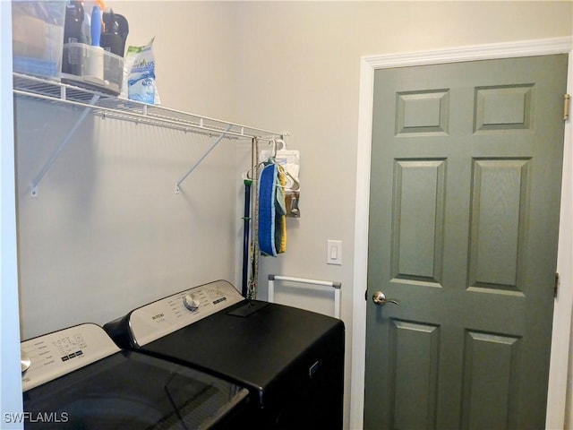 clothes washing area featuring washer and clothes dryer