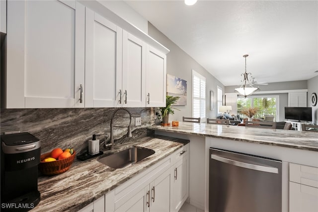 kitchen featuring light stone countertops, tasteful backsplash, stainless steel dishwasher, sink, and white cabinets