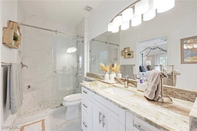 bathroom with a shower with door, vanity, and toilet