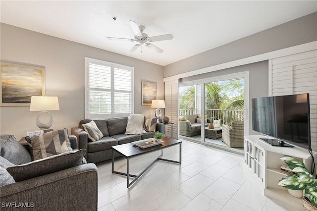 living room featuring ceiling fan and a healthy amount of sunlight