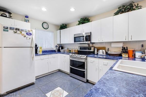 kitchen with sink, white cabinetry, and stainless steel appliances