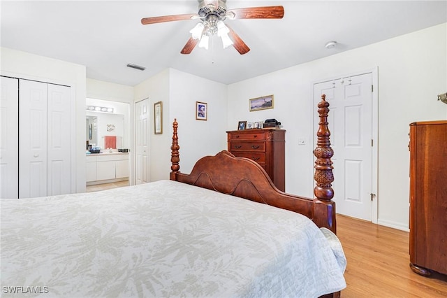 bedroom featuring ceiling fan, light hardwood / wood-style floors, and ensuite bath