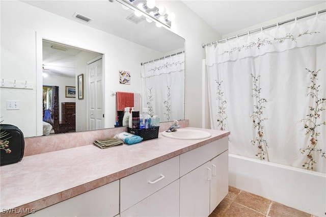 bathroom with tile patterned flooring, vanity, and shower / tub combo with curtain