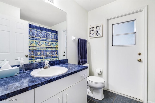 bathroom featuring tile patterned floors, vanity, and toilet