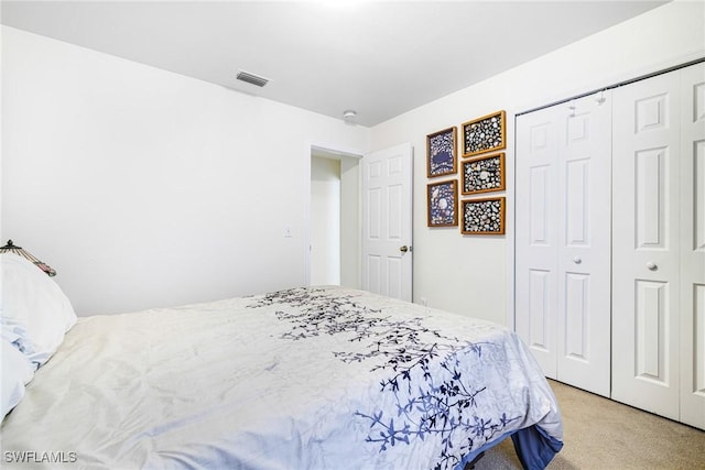 bedroom with light carpet and a closet