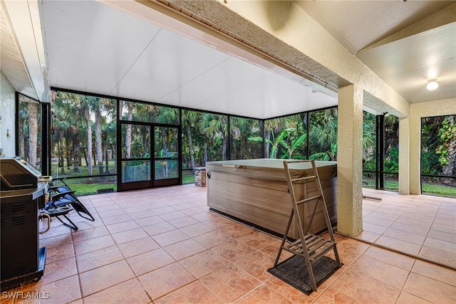 sunroom with vaulted ceiling and a hot tub