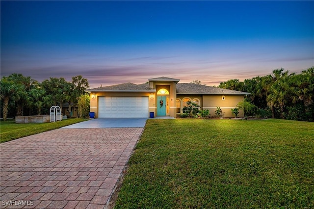 view of front of property with a lawn and a garage