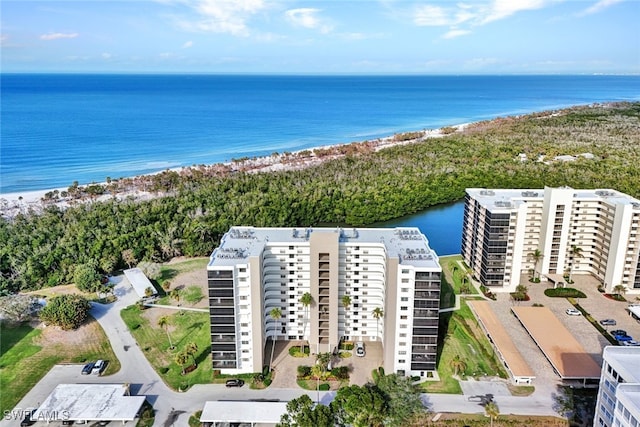 drone / aerial view featuring a water view and a view of the beach