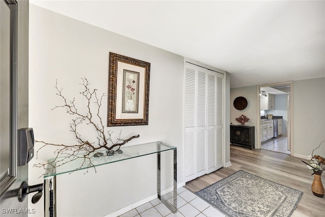 corridor with light hardwood / wood-style floors