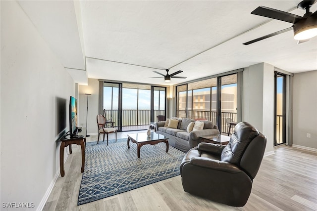 living room featuring floor to ceiling windows, a wealth of natural light, and light hardwood / wood-style flooring