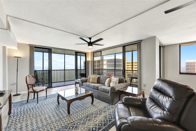 living room with hardwood / wood-style floors, ceiling fan, and floor to ceiling windows