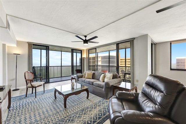 living room featuring hardwood / wood-style floors, floor to ceiling windows, and ceiling fan