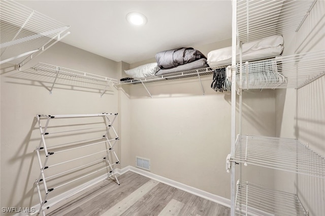 spacious closet featuring hardwood / wood-style flooring