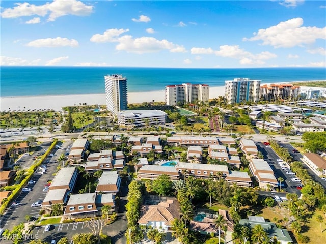 birds eye view of property featuring a water view and a beach view